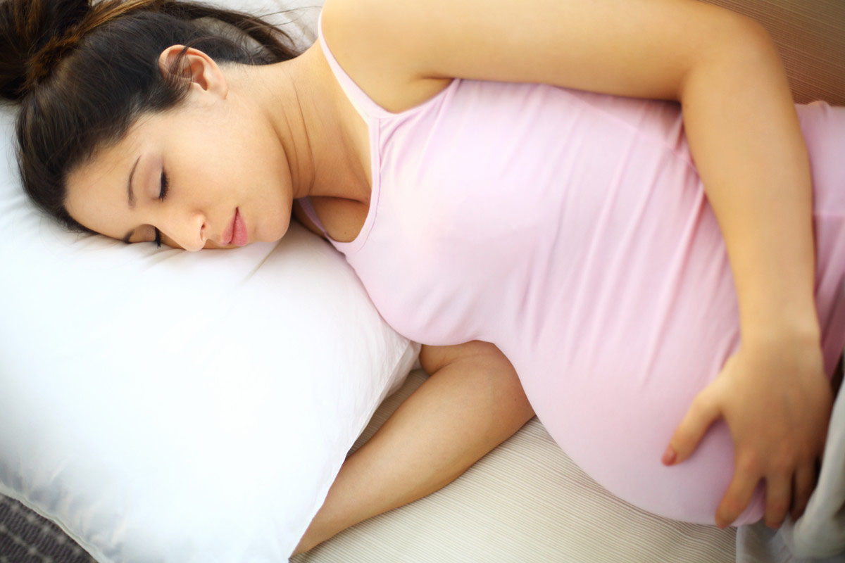 A pregnant woman lying on her side.