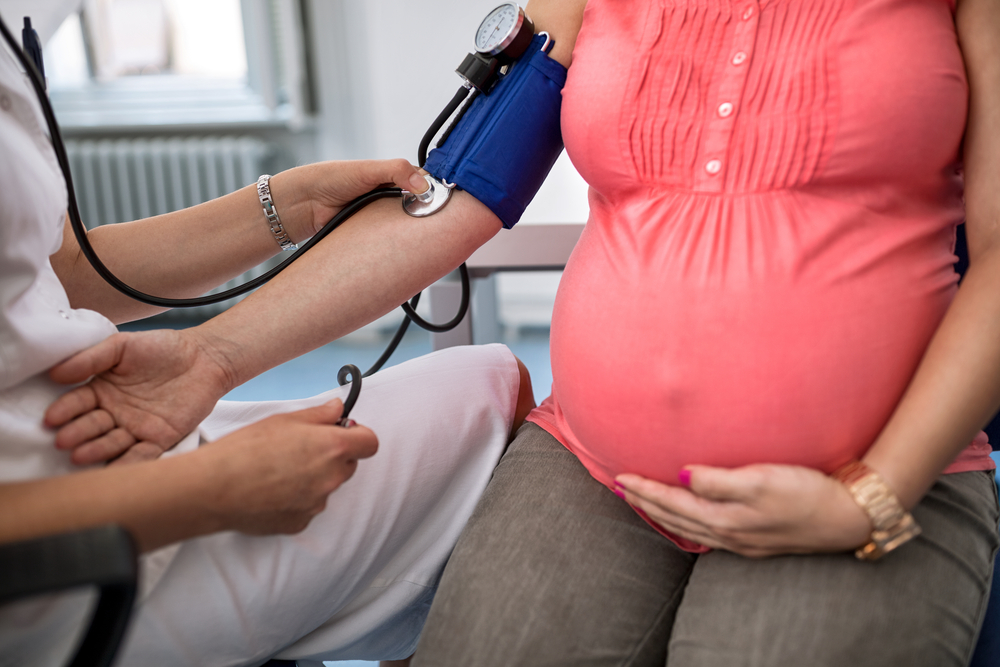 Checking blood pressure of pregnant woman