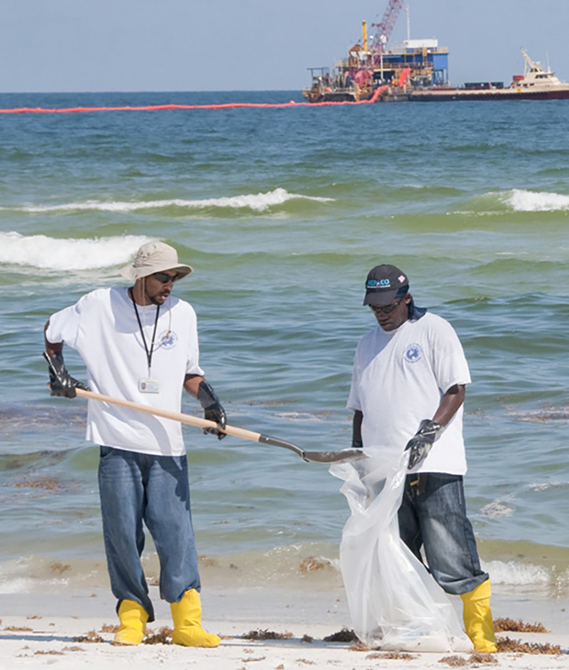 Image of men cleaning up a beach