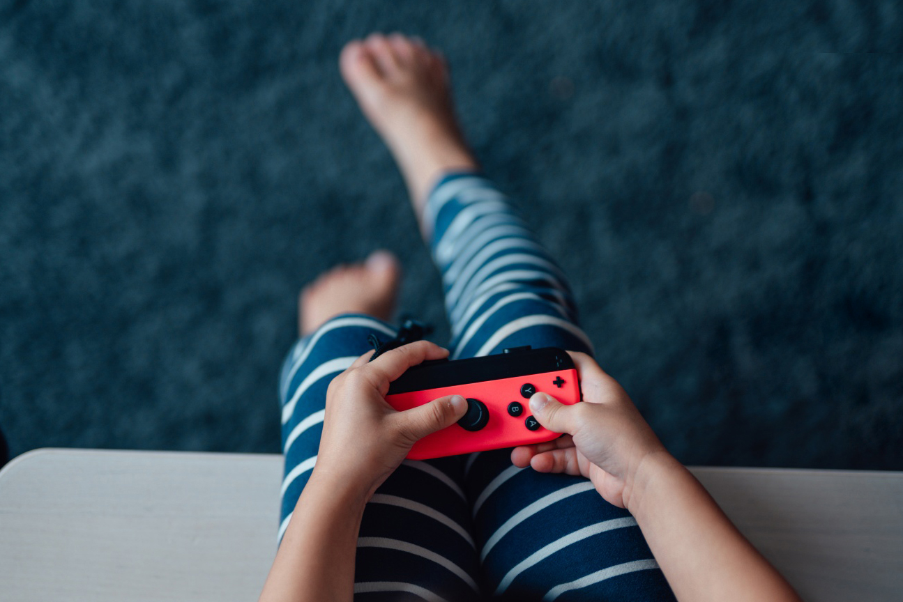 A child holding  a video game controller.