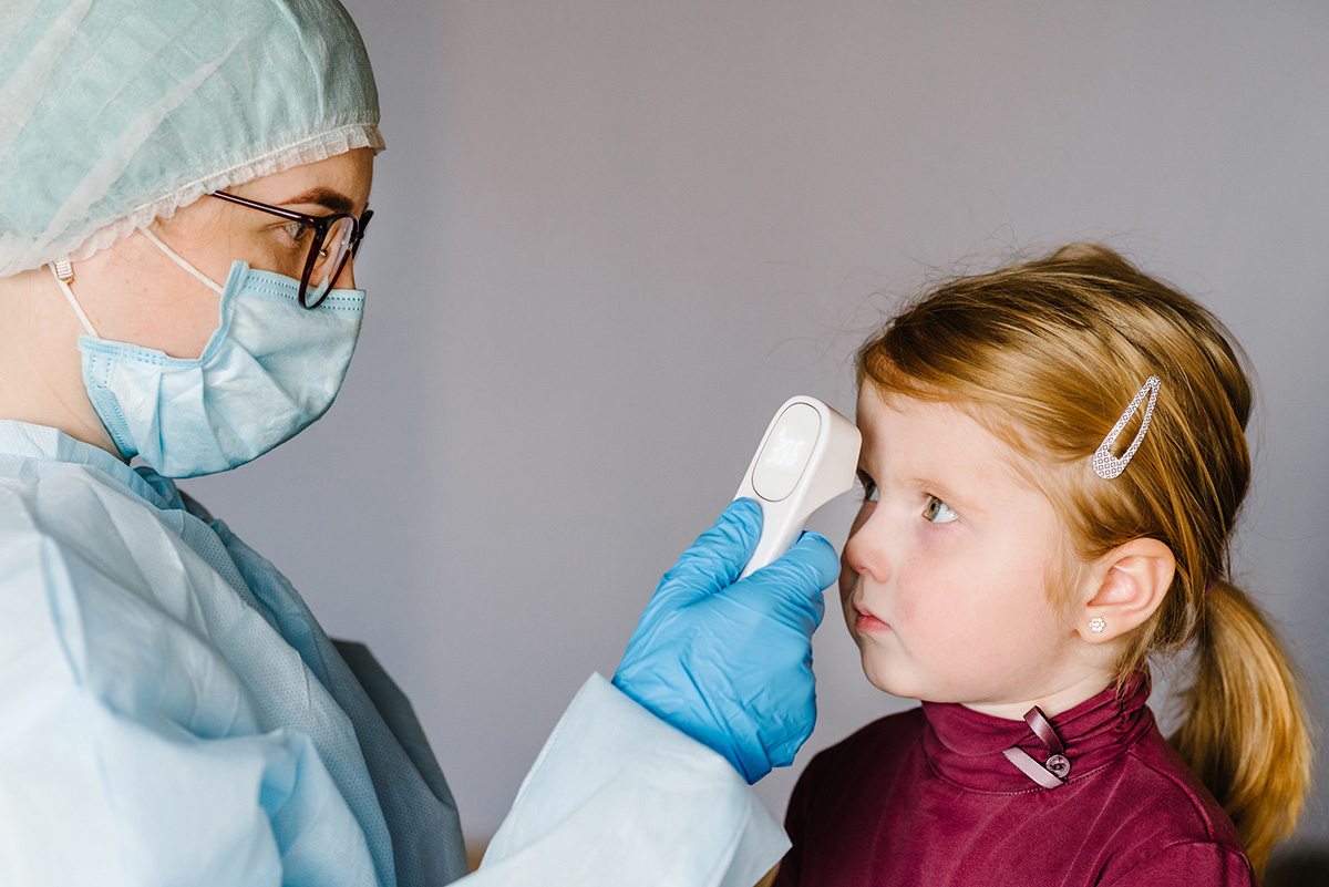 A child getting temp check.