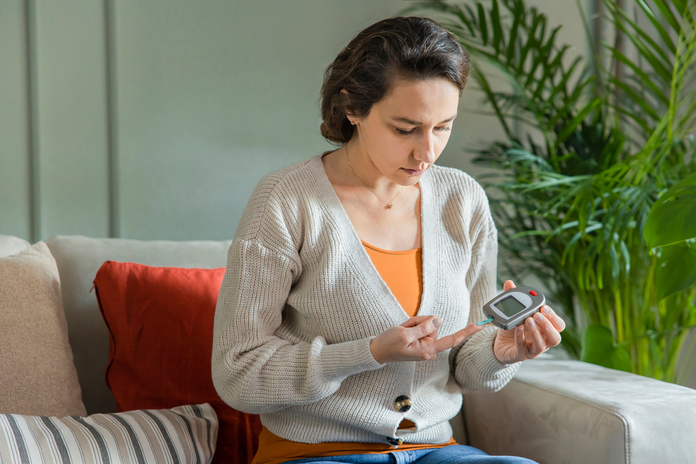 Image of a woman measuring blood sugar level