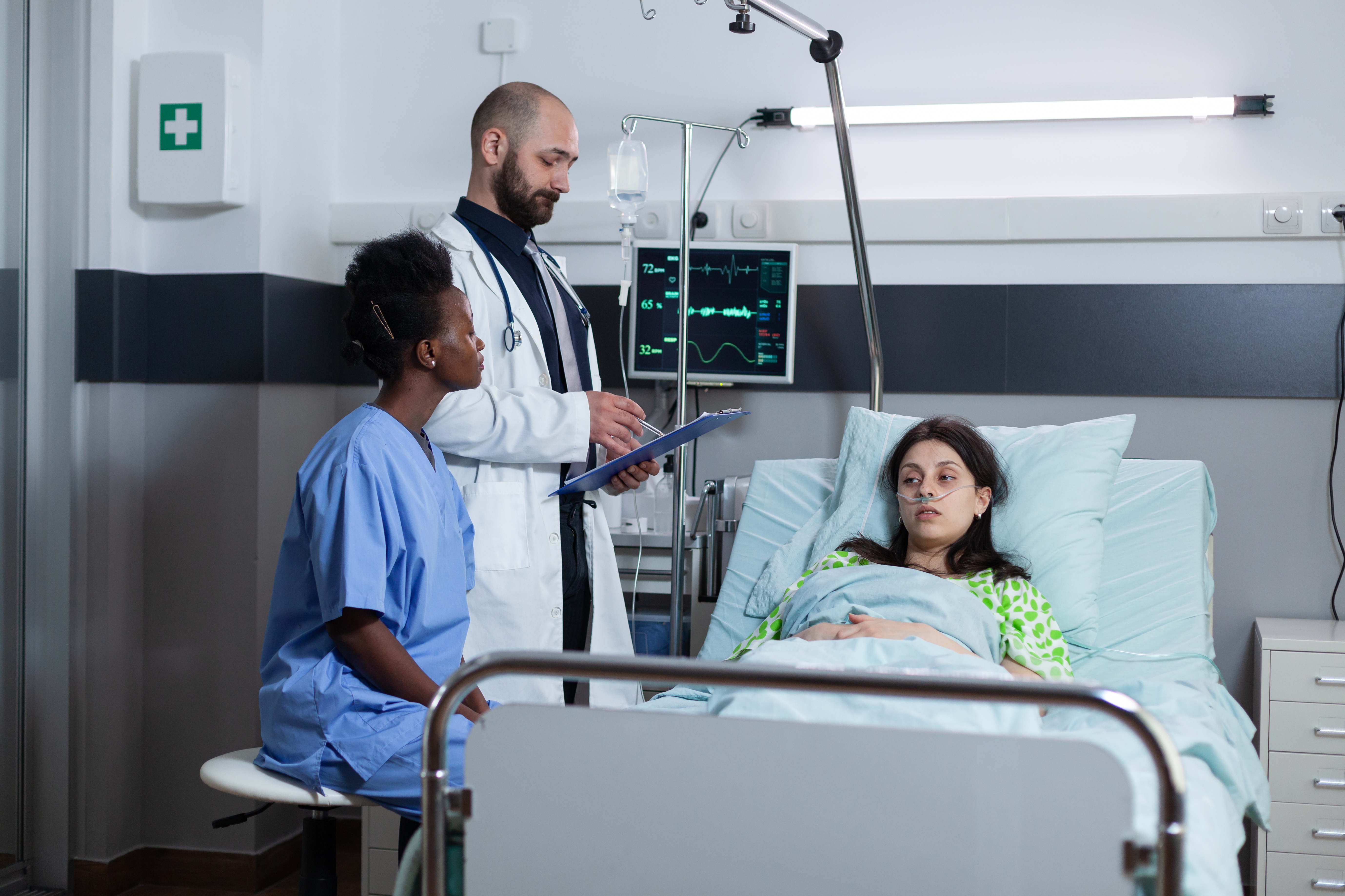 Photo of recovering young woman on hospital bed