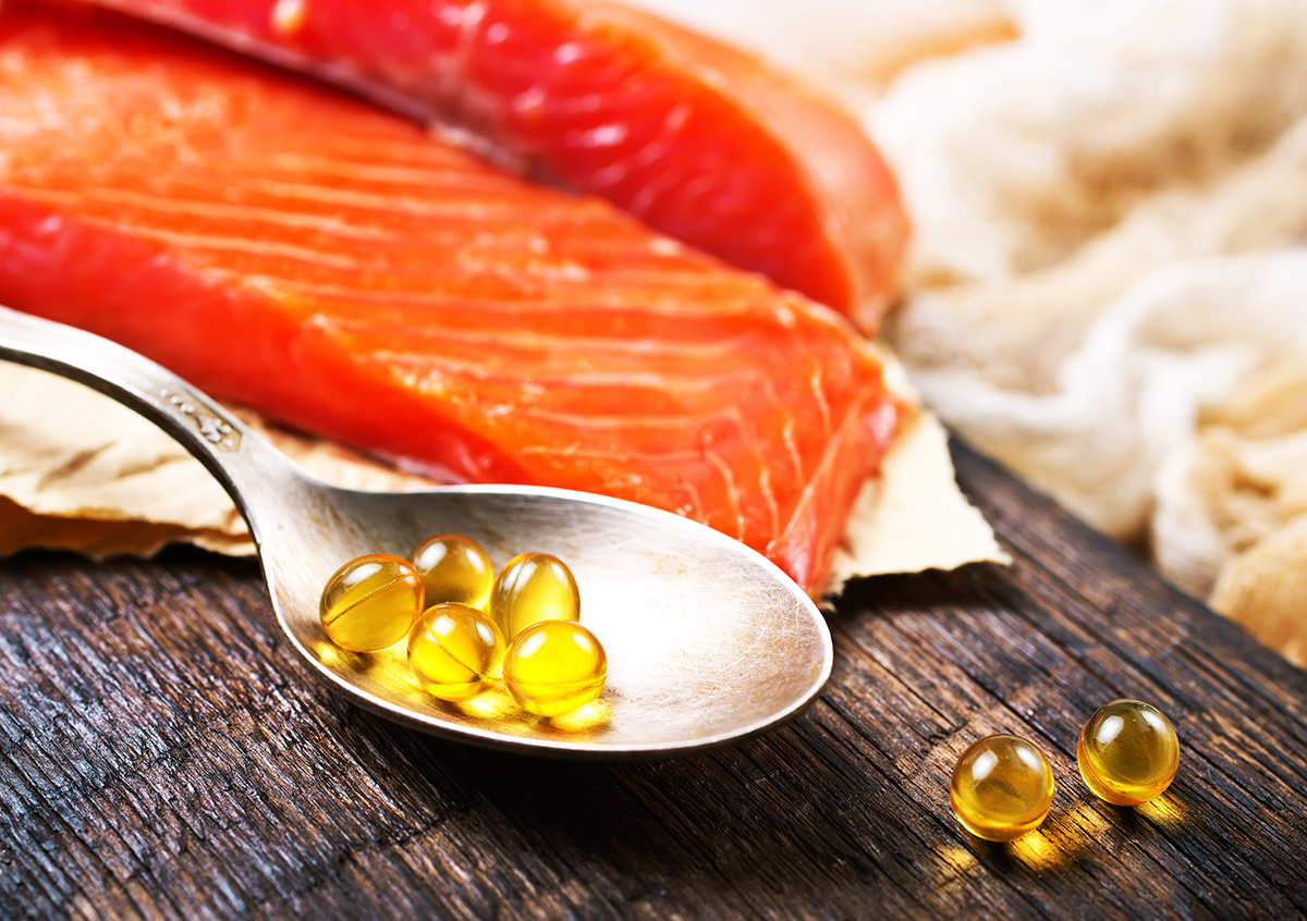 Image of fish oil pills and a salmon filet
