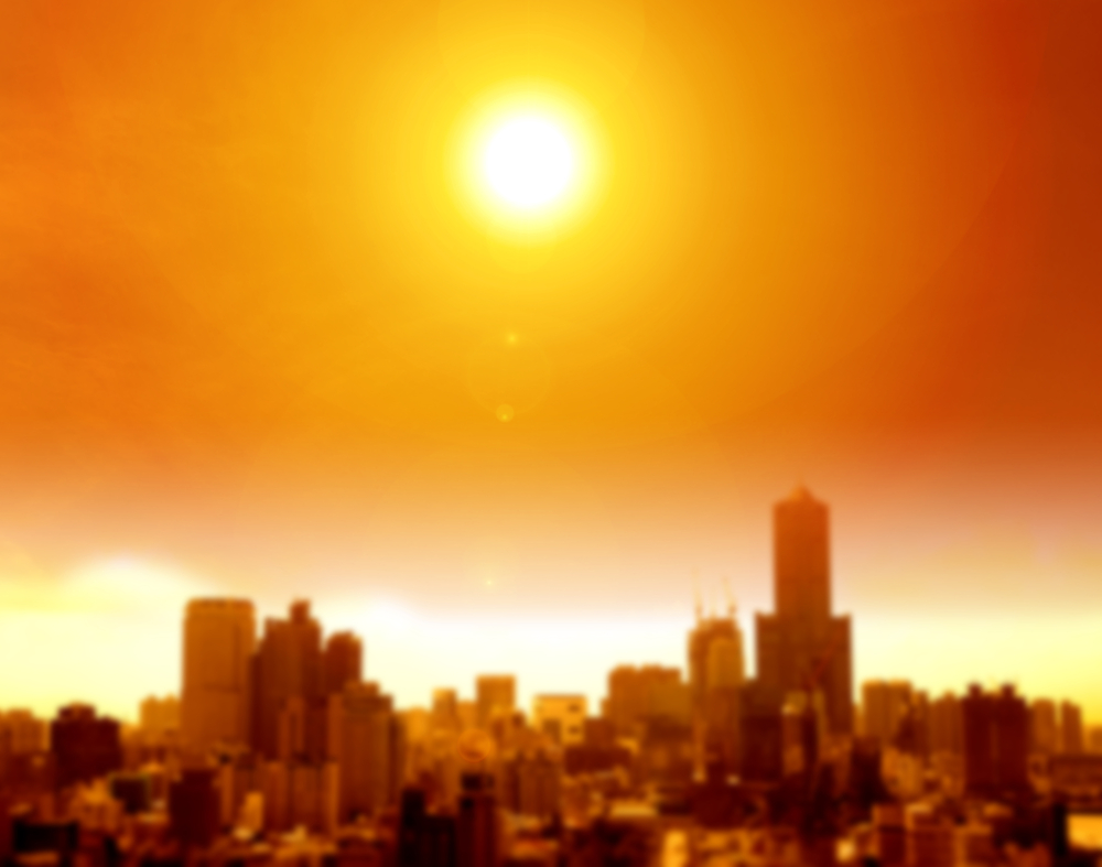 Image of a bright sun over a city skyline