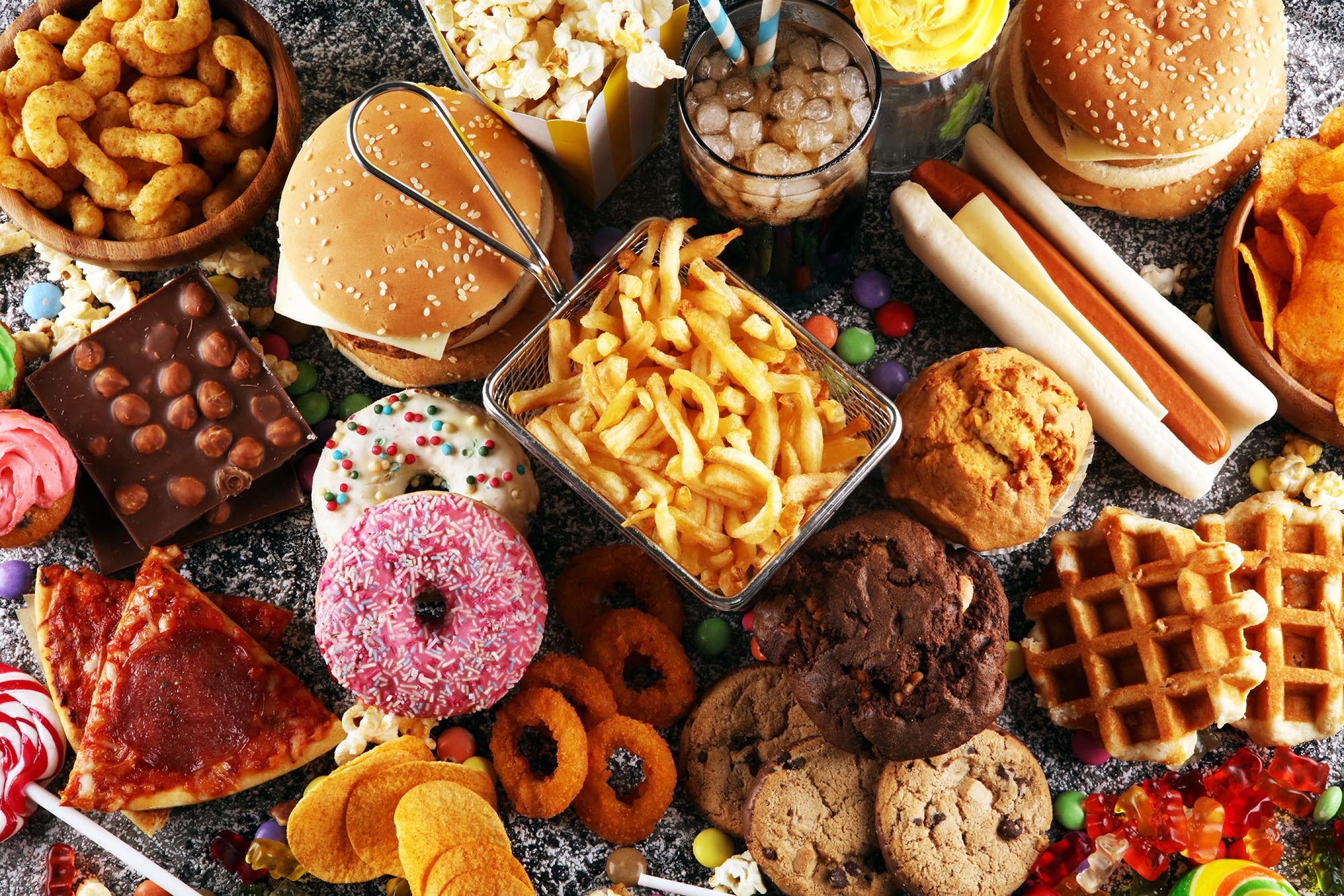 Image of many types of ultra-processed foods, including fries, hot dog, donuts, candy, soda, etc Image of many types of ultra-processed foods, including fries, hot dog, donuts, candy, soda, etc