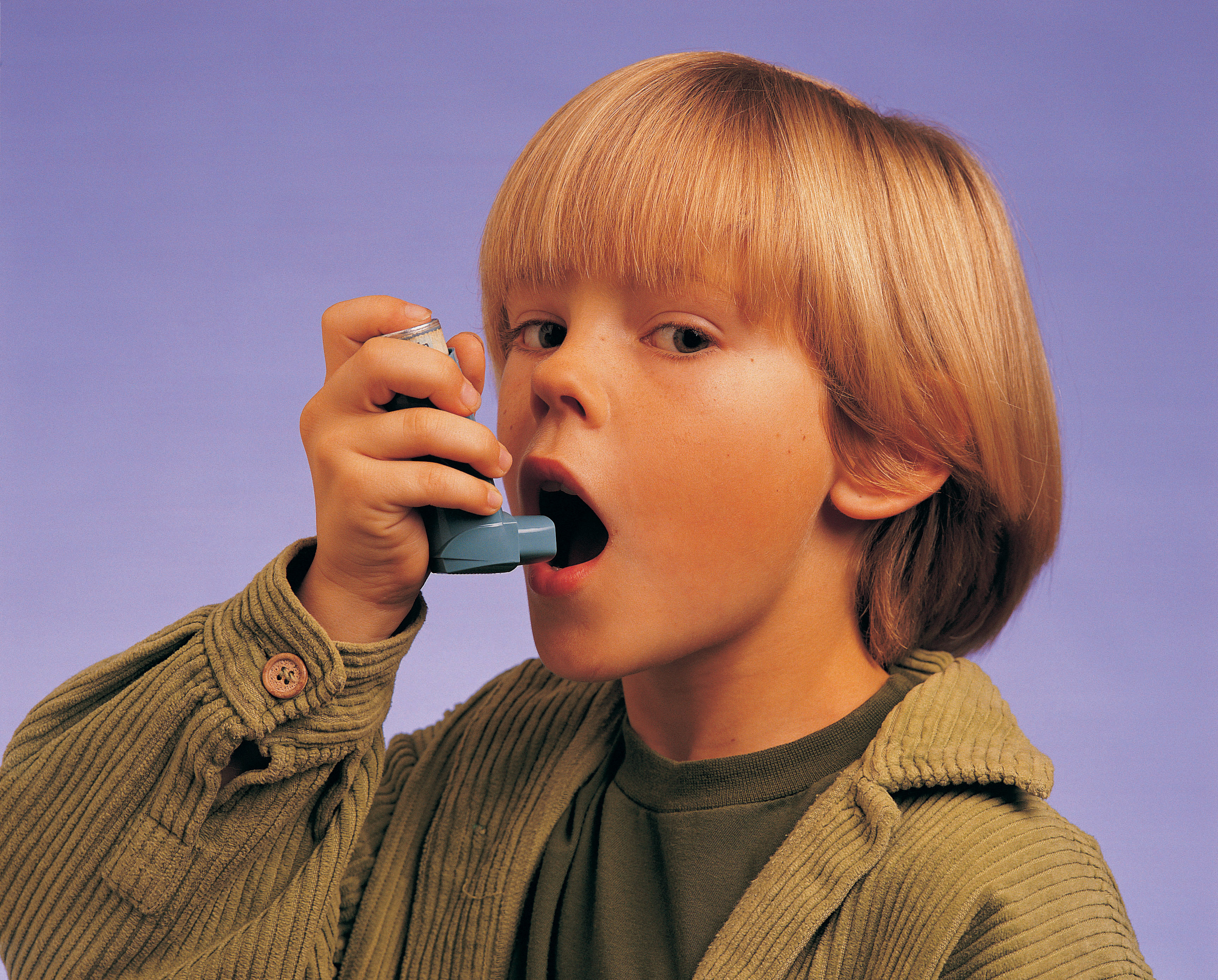 A young boy using an inhaler