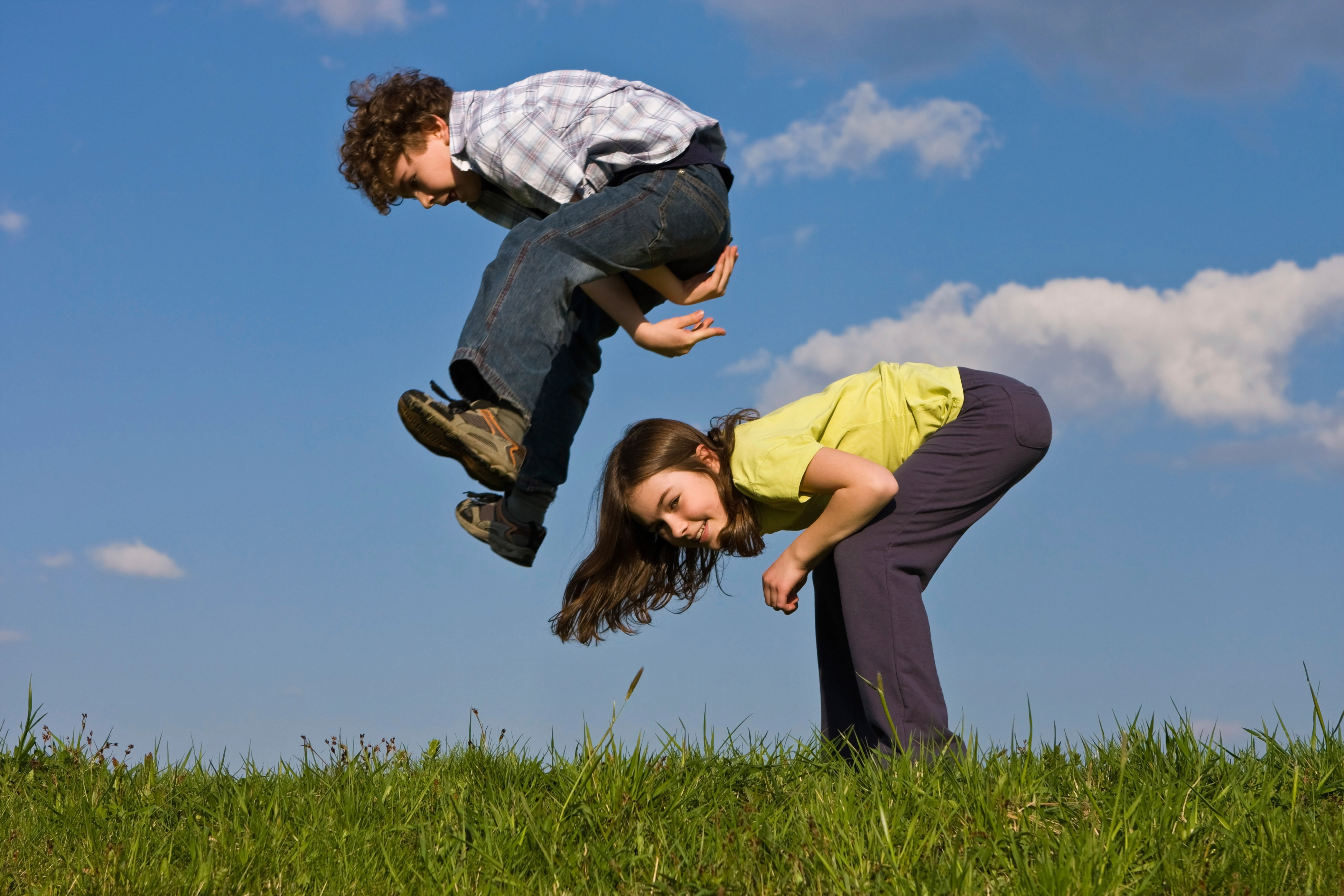 Photo of a boy and a girl playing leap frog