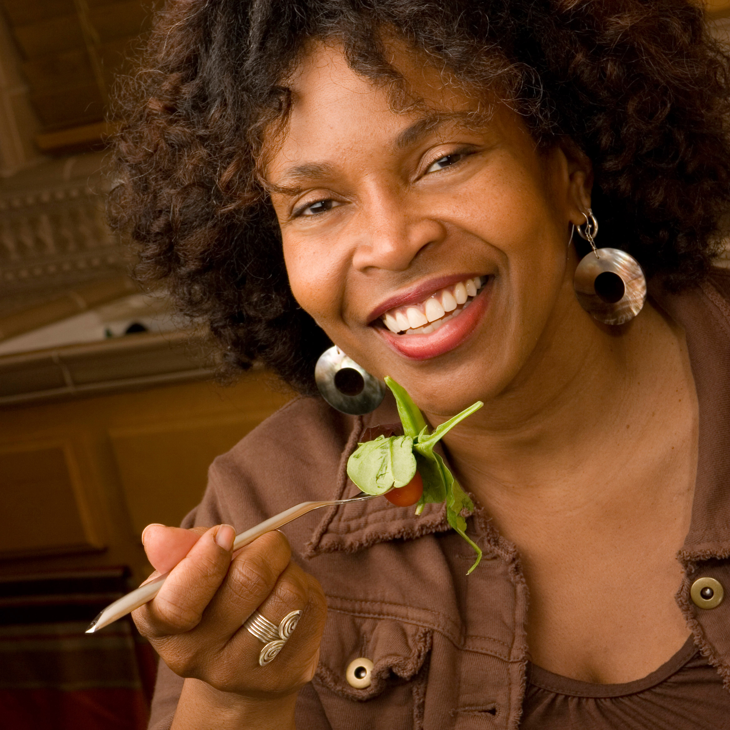 photo of a happy woman eating salad - cropped