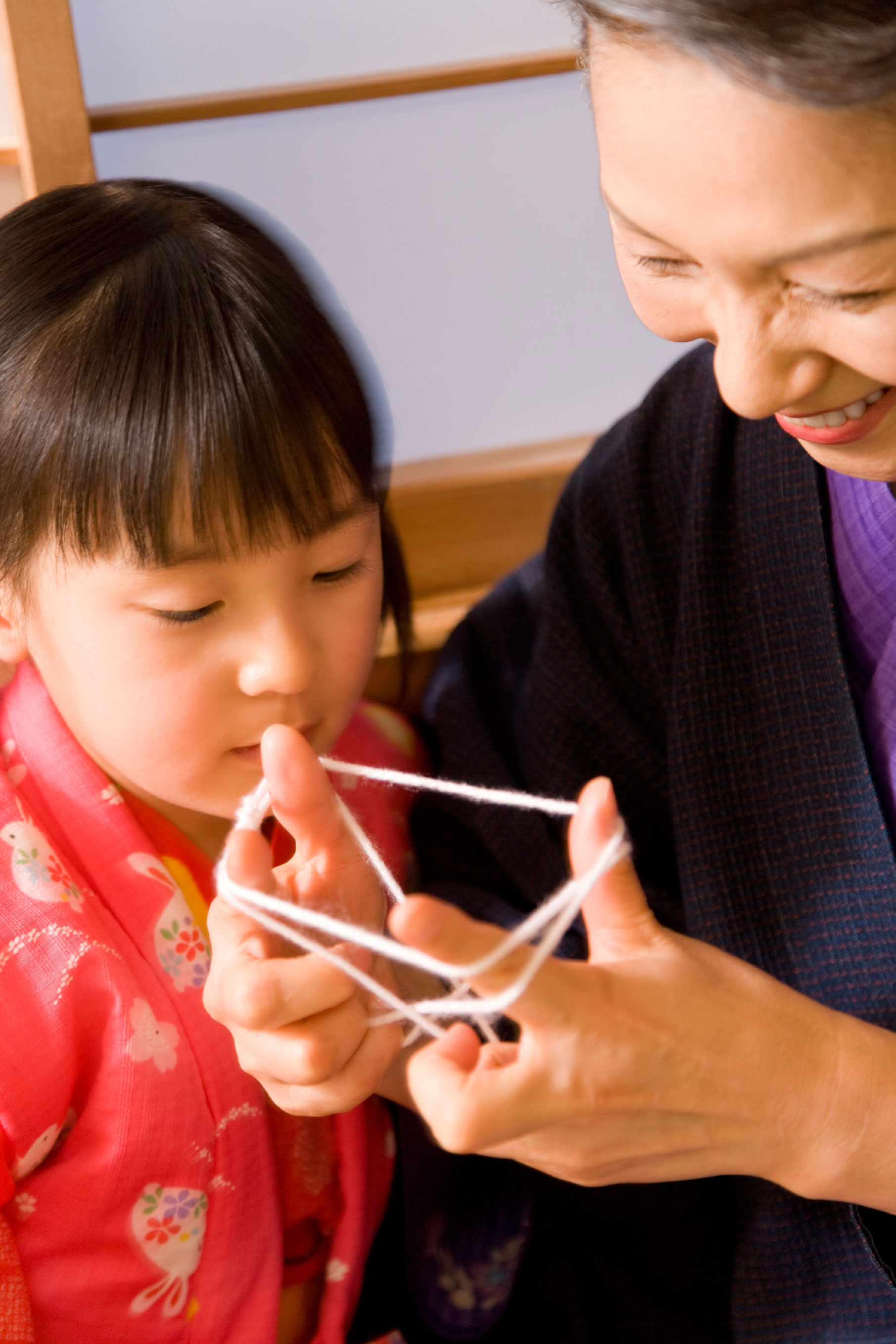 Female Asian senior citizen and her granddaughter.