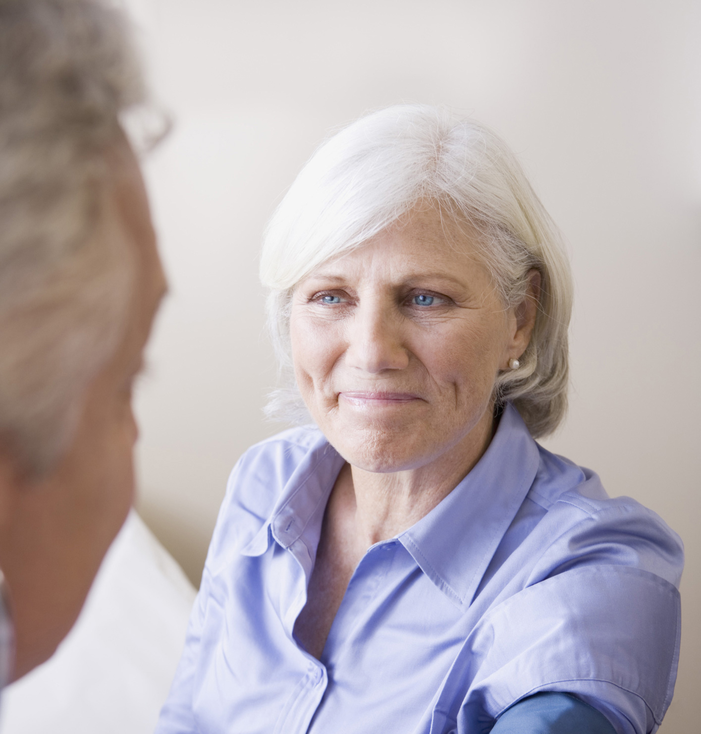Doctor taking woman’s blood pressure. Doctor taking woman’s blood pressure.