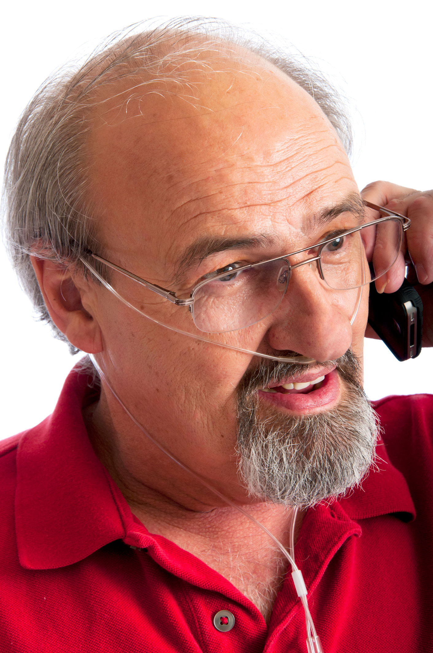 Man talking on the phone while receiving oxygen through a thin nasal tube.