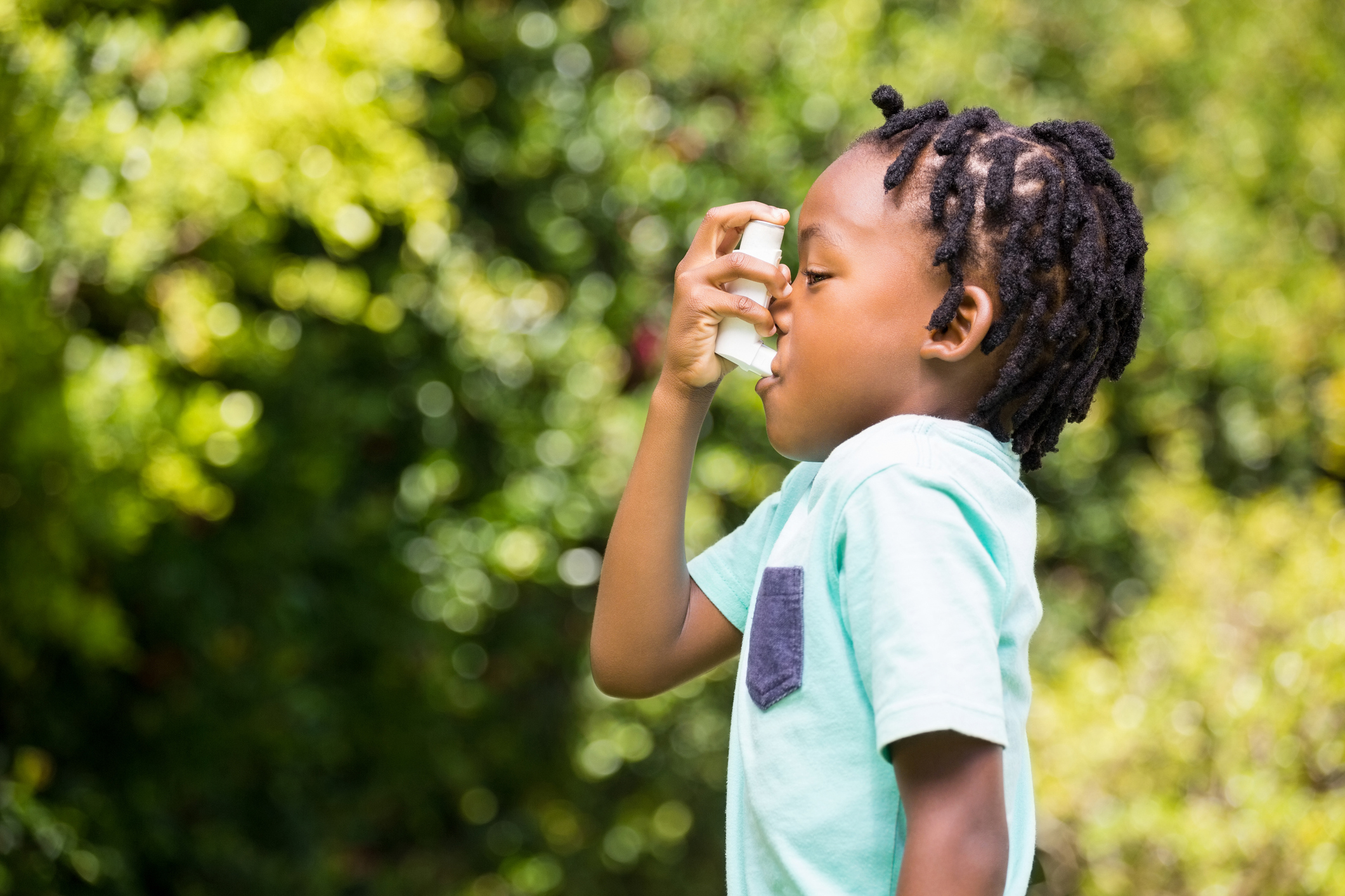 Child using an asthma inhaler