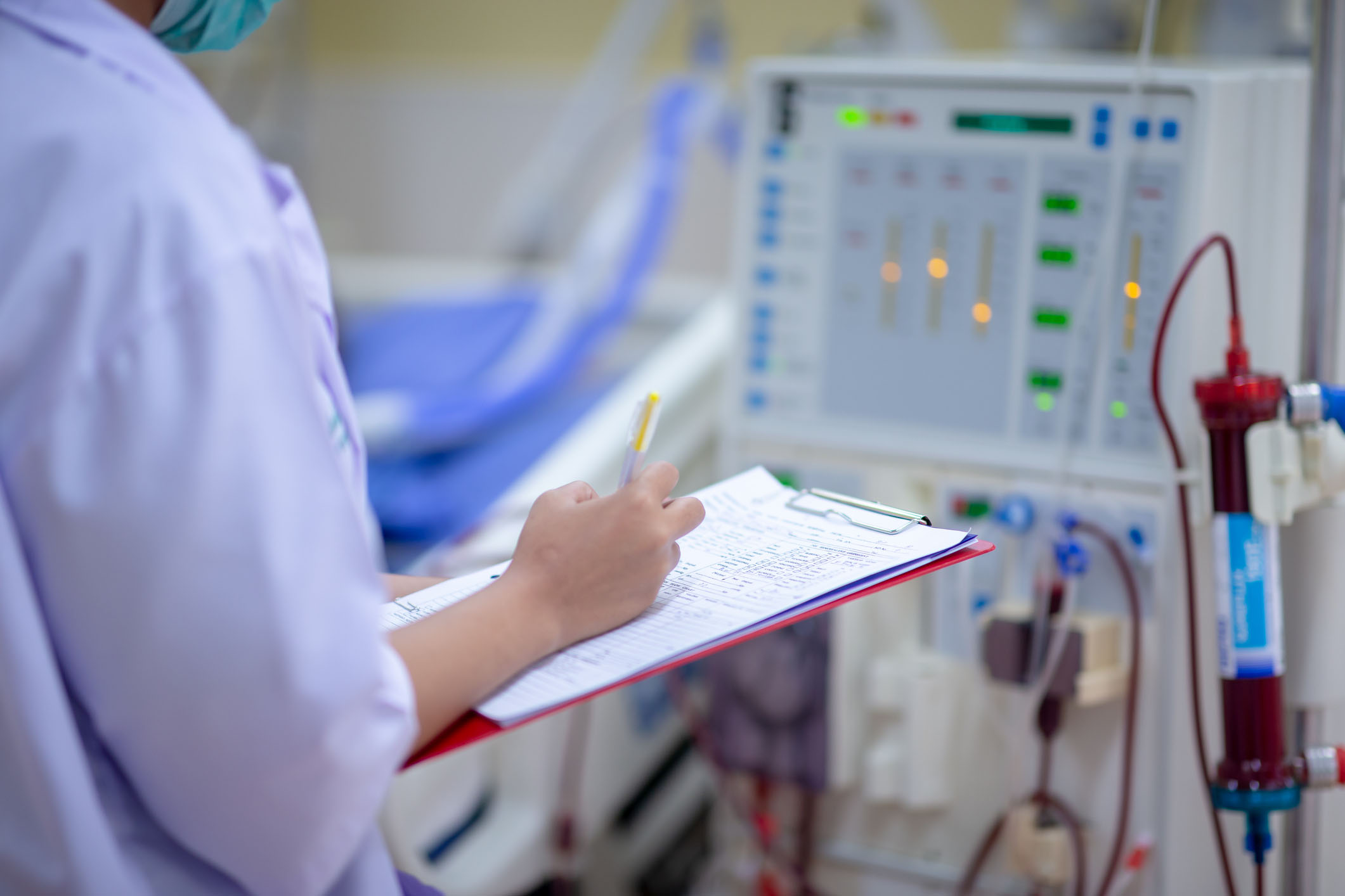 Nurse checking a dialysis machine Nurse checking a dialysis machine