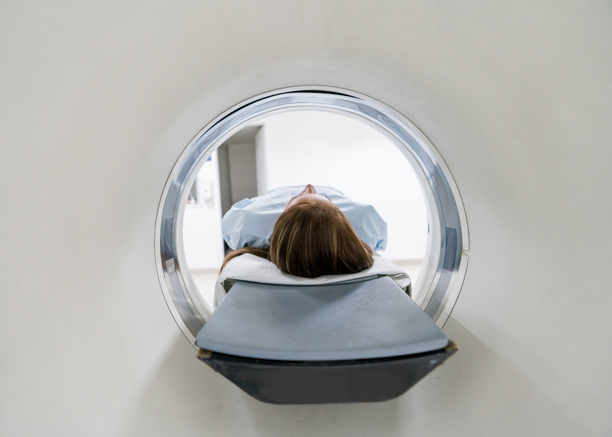 Female patient lying down for an MRI exam
