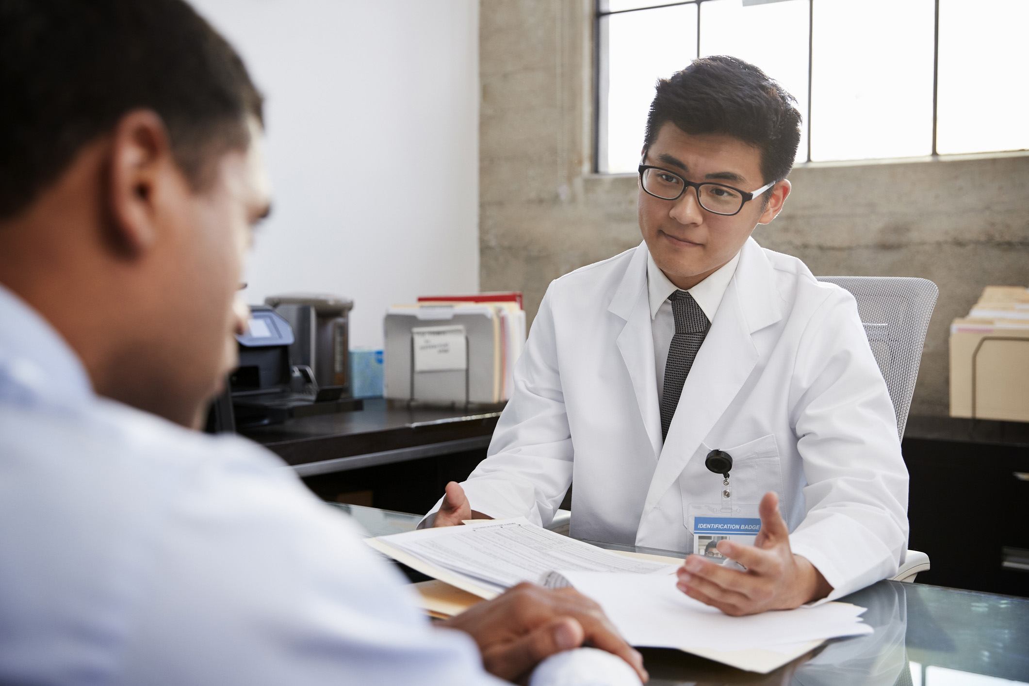 Doctor in consultation with male patient