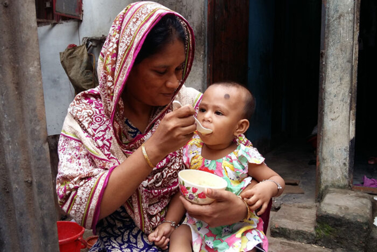 Mother feeding young child
