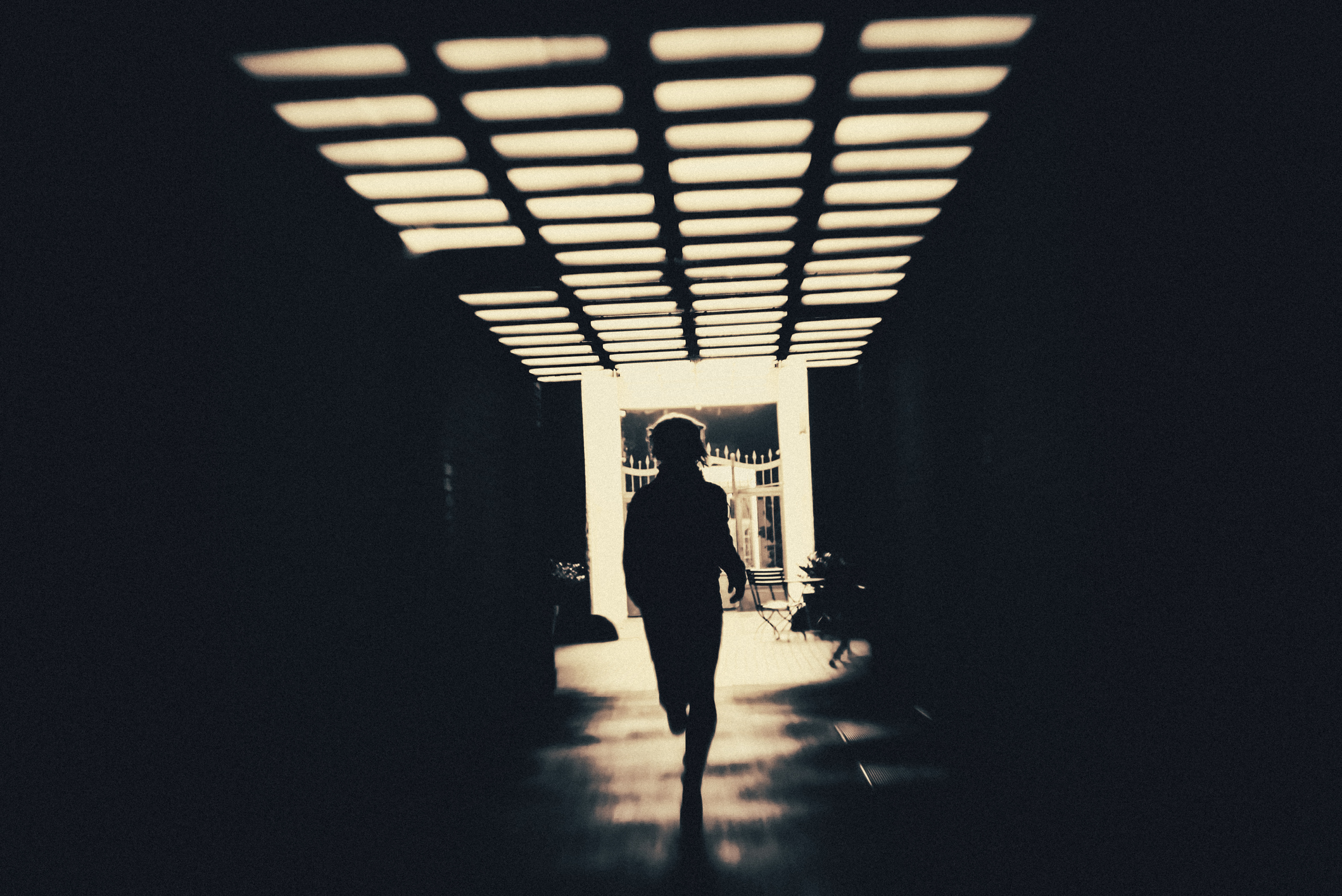 Person in shadow running through creepy underpass Person in shadow running through creepy underpass