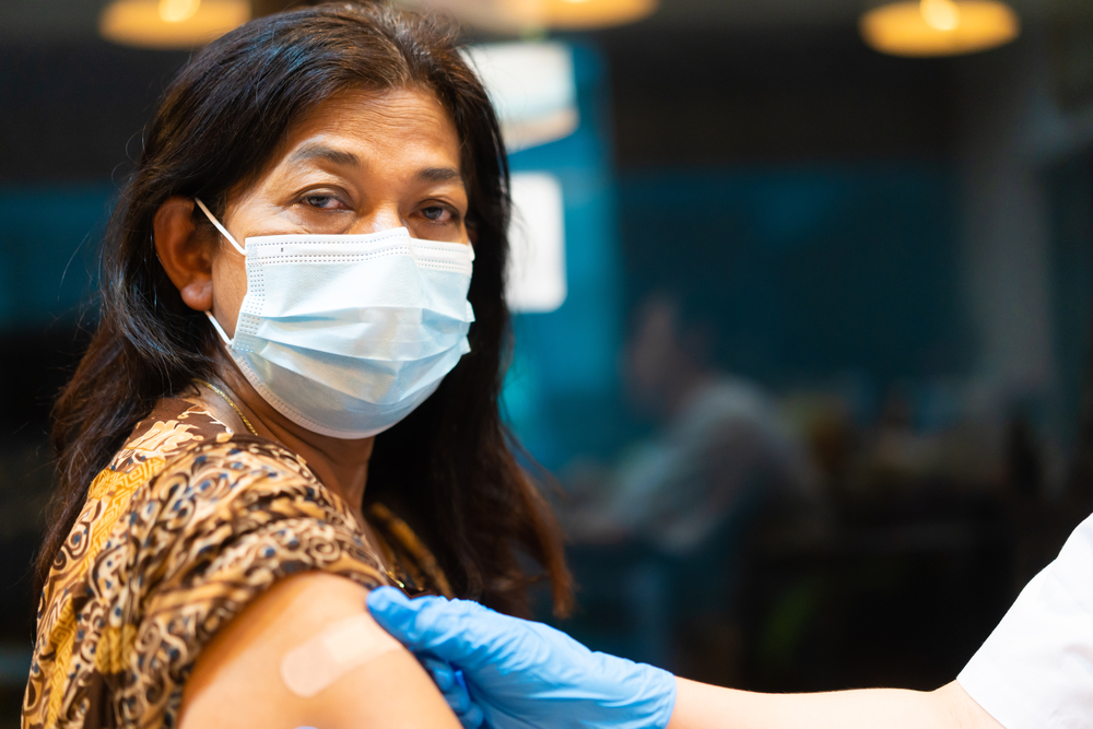 Woman getting vaccination in clinic. Woman getting vaccination in clinic.