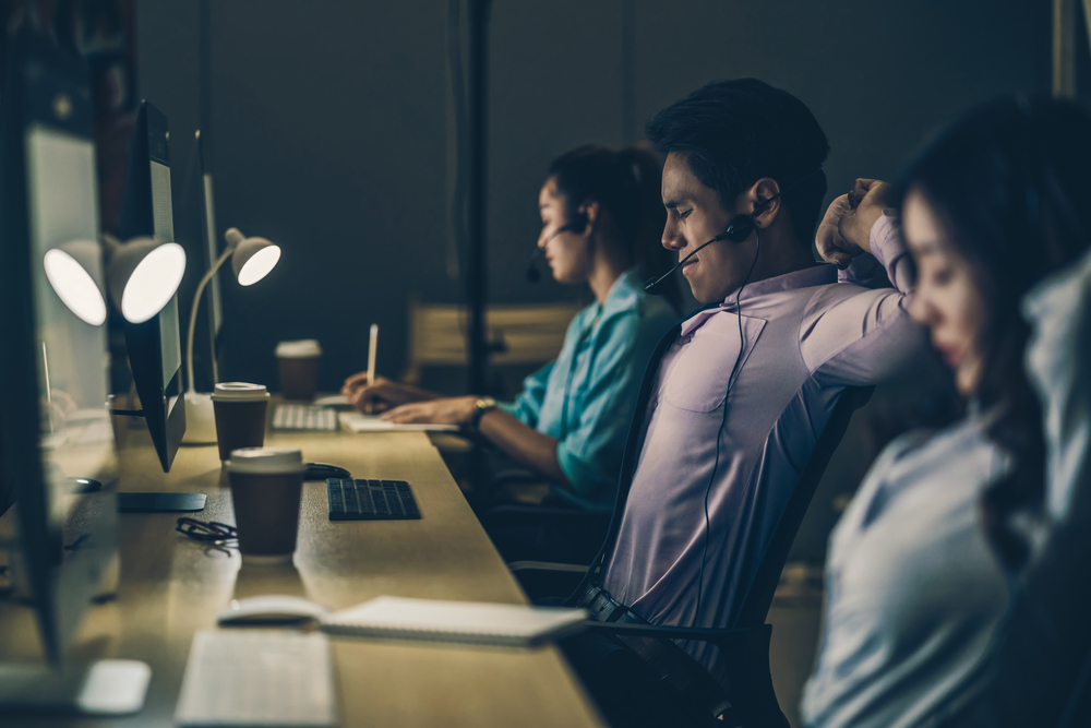 Tired night shift workers in office