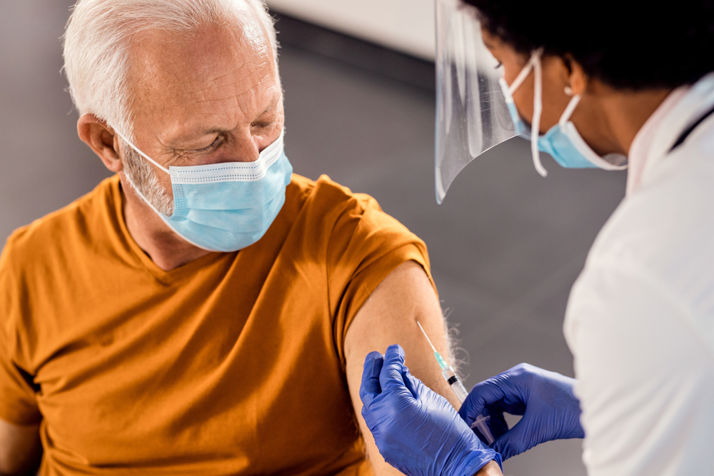 Senior man getting vaccinated at a medical clinic Senior man getting vaccinated at a medical clinic