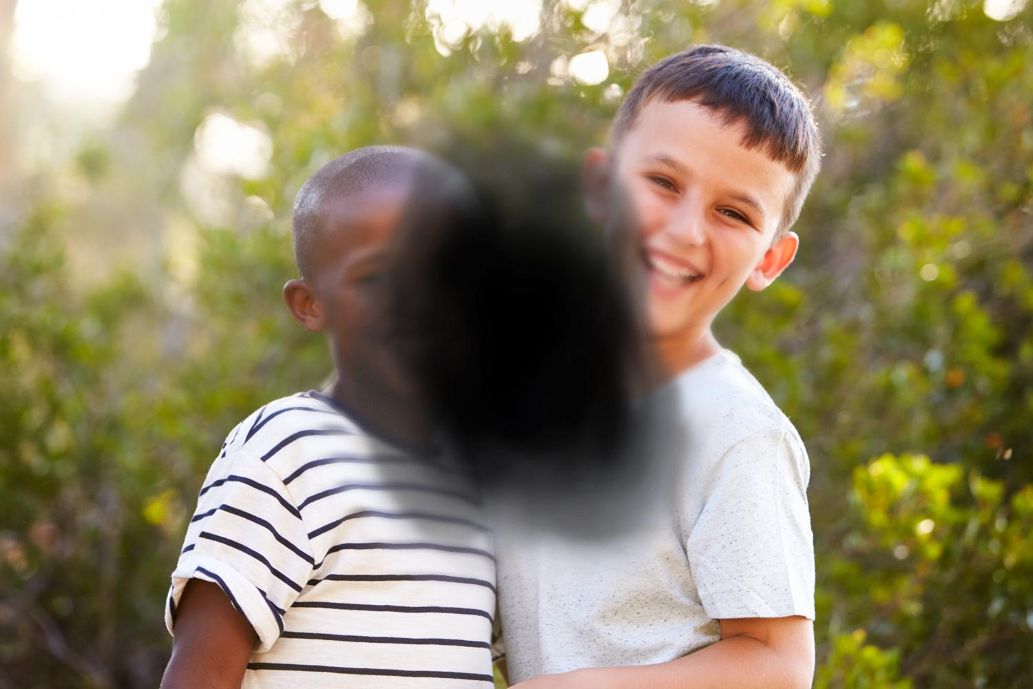 Two children obstructed by black splotch in center. Two children obstructed by black splotch in center.