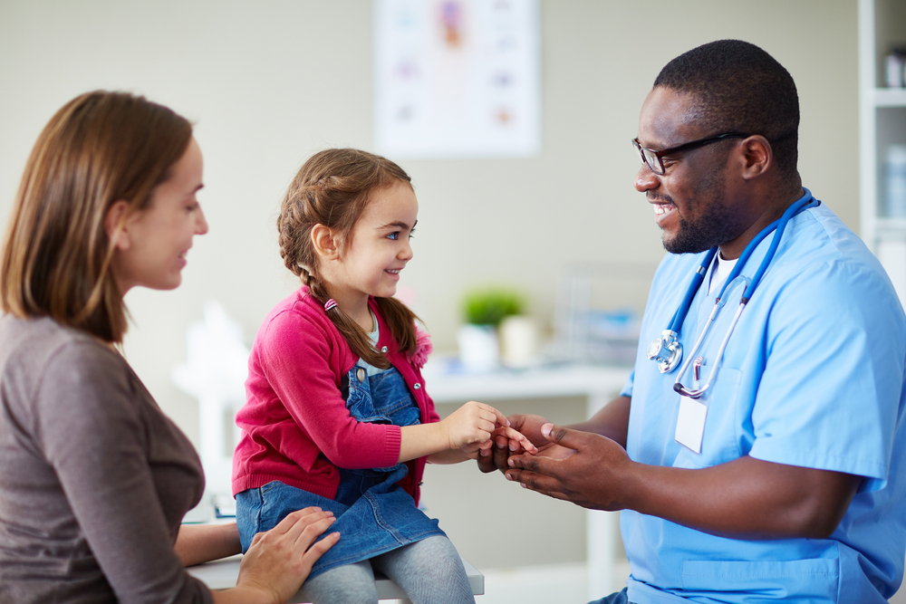Small child and doctor talking in clinic Small child and doctor talking in clinic