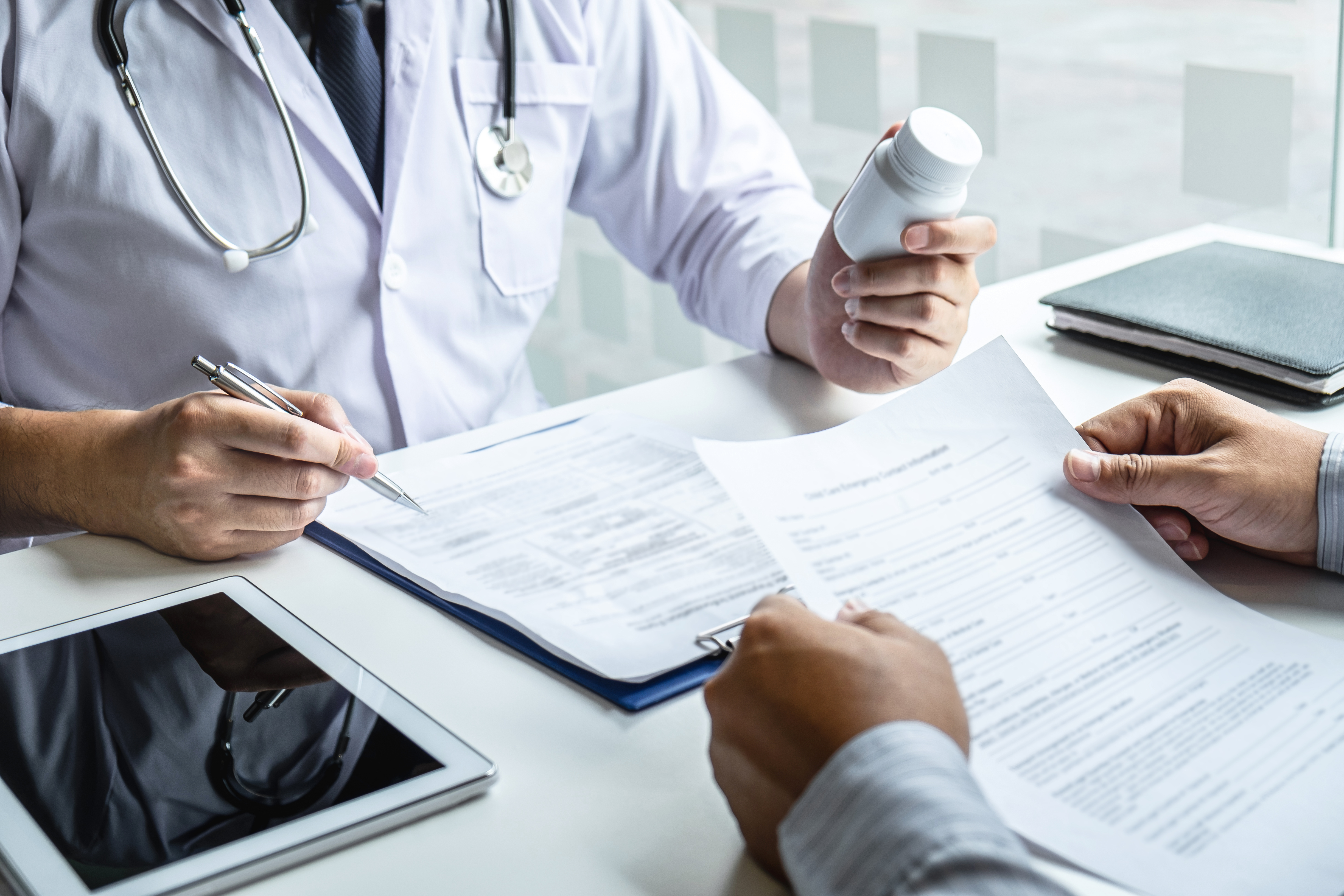 Doctor giving prescription to patient.