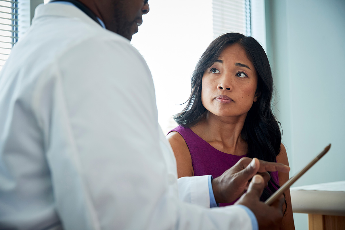 Doctor speaking with a female patient. Doctor speaking with a female patient.