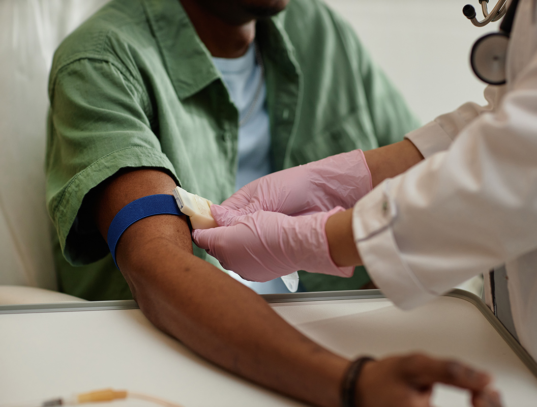 Nurse preparing a patient's arm for a blood test Nurse preparing a patient's arm for a blood test