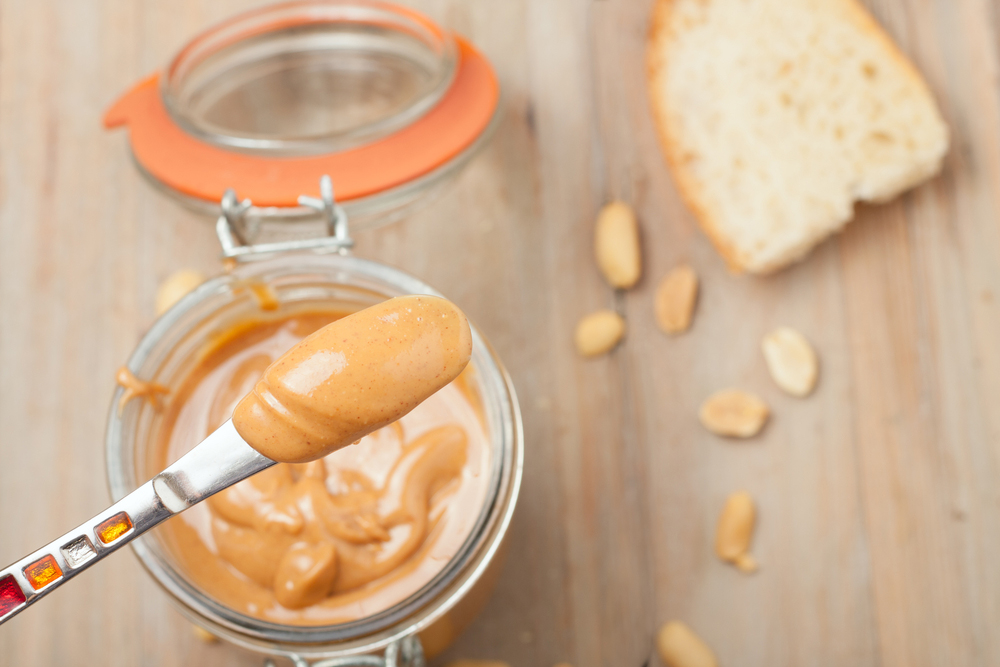 A small amount of peanut butter on a knife. A small amount of peanut butter on a knife.