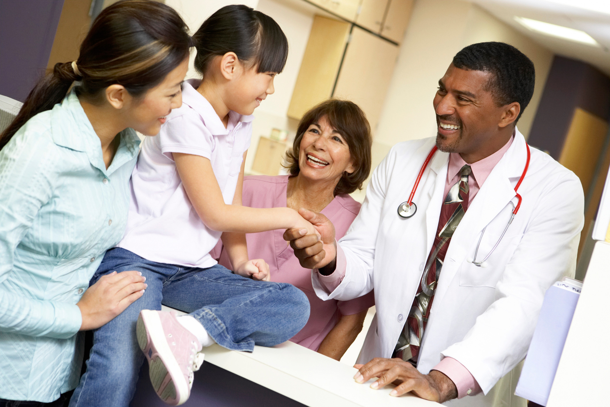 A family with child in the doctors office.