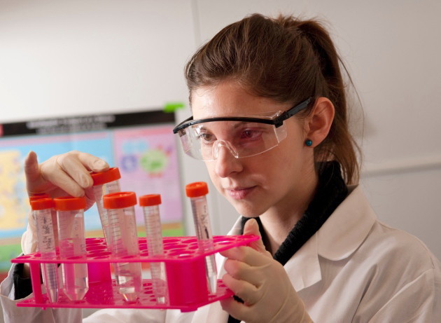 An NIH laboratory scientist examines a specimen.