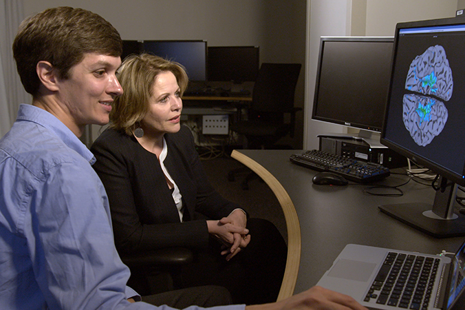 Renée Fleming and David Jangraw look at brain scan