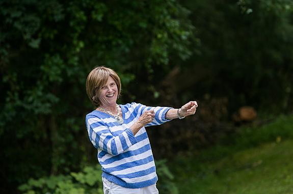 Woman standing outside and smiling at the camera.