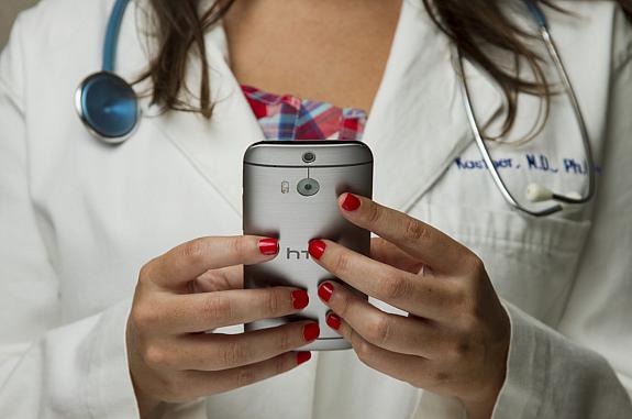 Doctor holding a cell phone. 