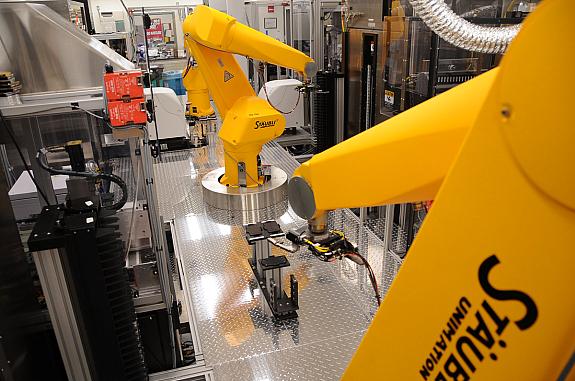 A yellow robotic arm that can be programmed by scientists to conduct high-throughput small molecule screening.
