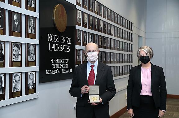 Dr. Harvey Alter poses with Swedish ambassador Karin Olofsdotter in the Nobel Laureates Hall at NIH on December 8, 2020 after a ceremonial presentation of the Nobel medal and diploma.