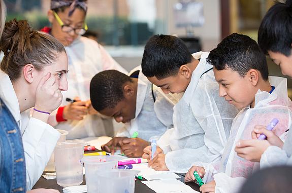 Middle school students doing a group project activity