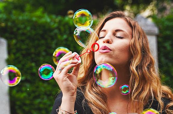 Woman blowing bubbles