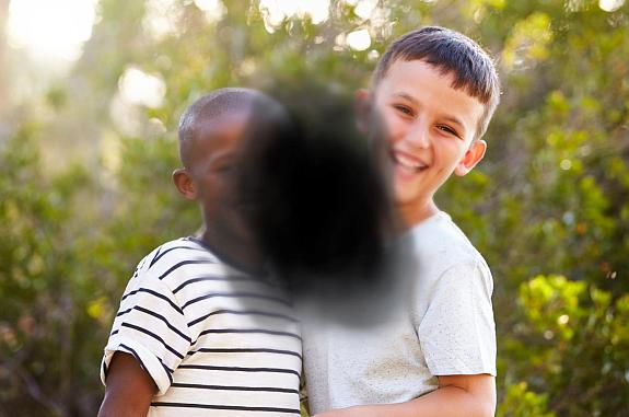 Two children obstructed by black splotch in center.