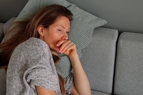 Tired woman lying on sofa.