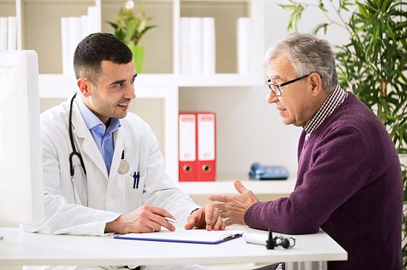 Doctor talking to older male patient.