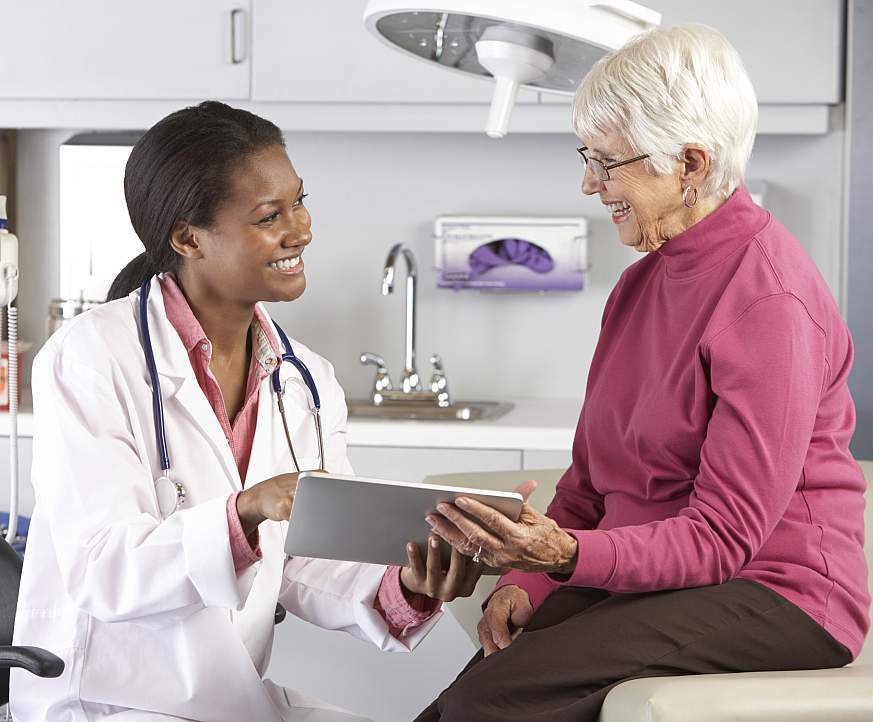 Photo of a doctor speaking with a patient.
