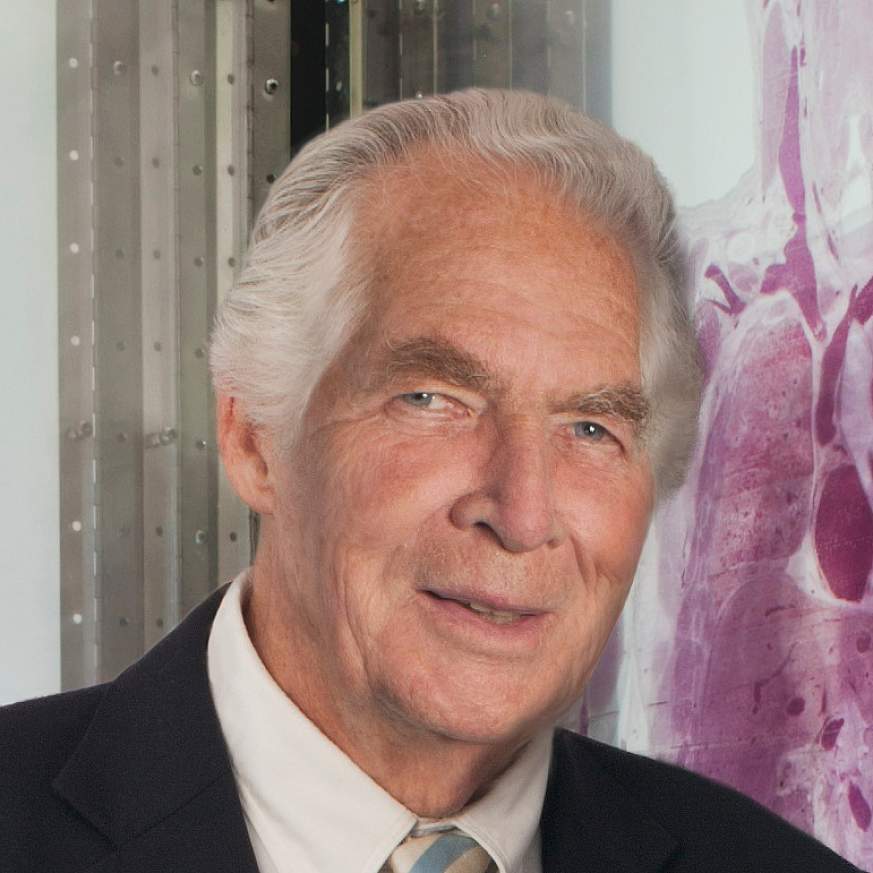 Donald A.B. Lindberg, M.D., Director, National Library of Medicine, positioned in front of NLM's backlit lucite transparency of its Visible Humans.