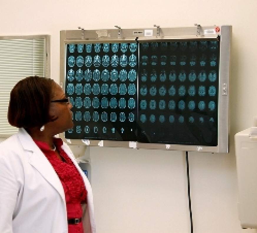 Nurse practitioner views CT scan.