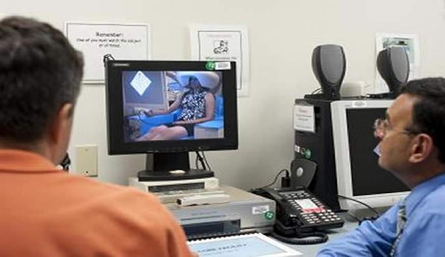 Scientist monitors patient in scanner