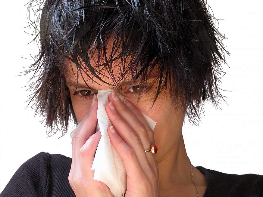 A woman blowing her nose.