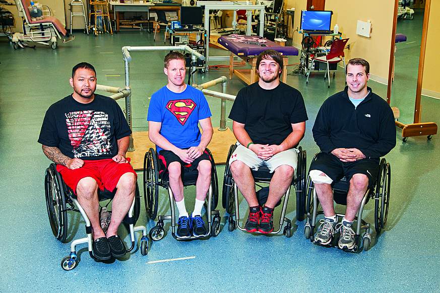 Four men sitting in wheelchairs.