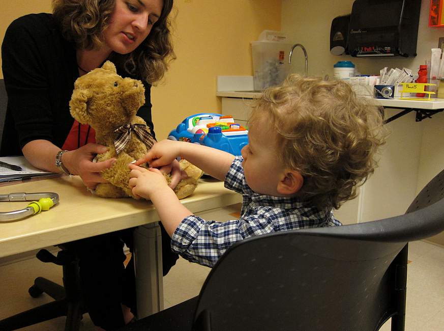 Image of a nurse speaking to a young boy